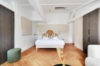 a bedroom with a white bed and wooden floors at Brand New Modern Studio in Central Paris - 2P - B6 in Paris