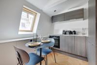 a kitchen with a table and chairs in a kitchen at Brand New Modern Studio in Central Paris - 2P - B6 in Paris