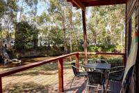 a deck with a table and chairs on a porch at Lorne Foreshore Caravan Park in Lorne