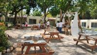 a group of picnic tables in a courtyard with people at HOTEL ISLA in Isla Aguada