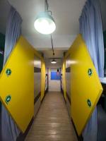 a hallway with yellow lockers in a room at Hive Bed and Backpacker蜂巢膠囊旅店 in Hualien City