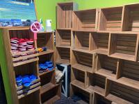 a room with wooden shelves filled with shoes at Hive Bed and Backpacker蜂巢膠囊旅店 in Hualien City