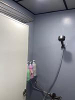 a bathroom with a shower head in a room at Hive Bed and Backpacker蜂巢膠囊旅店 in Hualien City