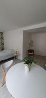 a living room with a white table and a couch at Agréable studio in Bourgueil