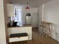 a small kitchen with a counter and a refrigerator at Clos Léonie - appartement 68m2 lumineux avec sauna in Givry