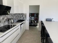 a kitchen with white cabinets and a counter top at Villa de standing in Calvi