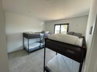 a bedroom with two bunk beds and a window at Villa de standing in Calvi