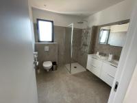 a bathroom with a shower and a toilet and a sink at Villa de standing in Calvi