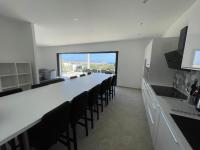 a large white room with a long table and chairs at Villa de standing in Calvi