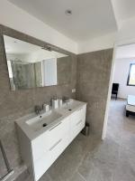 a bathroom with a white sink and a mirror at Villa de standing in Calvi
