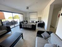 a living room with two couches and a table at Villa de standing in Calvi