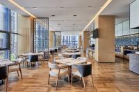 a restaurant with tables and chairs and windows at Fairfield by Marriott Zibo in Zibo