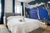 a bedroom with a white bed and a blue wall at Renovated studio in the 6th district of Paris - Welkeys in Paris