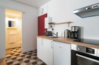 a kitchen with white cabinets and a checkered floor at Renovated studio in the 6th district of Paris - Welkeys in Paris