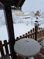 a table covered in snow next to a fence at Lucija in Lovinac