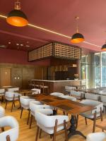 a restaurant with wooden tables and white chairs at Tryp by Wyndham Brasília Nações in Brasilia