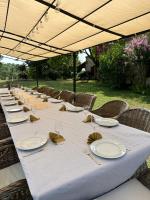 a long table with plates and napkins on it at Manoir du Suquet in Bardou