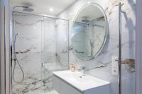 a bathroom with a shower and a sink and a mirror at La Bastide Bourrelly - Mathias Dandine in Cabriès