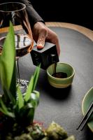 a person pouring wine into a bowl on a table at Academias Hotel, Autograph Collection in Athens