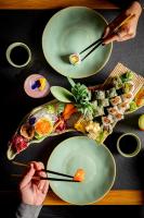 two plates of food with chopsticks on a table at Academias Hotel, Autograph Collection in Athens