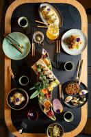 a wooden table with plates of food on it at Academias Hotel, Autograph Collection in Athens