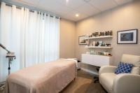 a hospital room with a bed and a chair at Sutton Place Hotel Revelstoke Mountain Resort in Revelstoke
