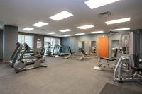a gym with several treadmills and elliptical machines at Sutton Place Hotel Revelstoke Mountain Resort in Revelstoke