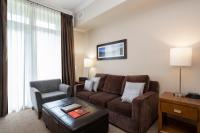 a living room with a couch and a chair at Sutton Place Hotel Revelstoke Mountain Resort in Revelstoke