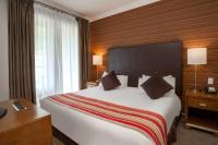 a hotel room with a large bed and a window at Sutton Place Hotel Revelstoke Mountain Resort in Revelstoke