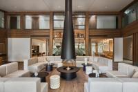 a living room with white furniture and a large fireplace at Monist Palanga boutique by SPA VILNIUS in Palanga
