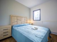 a bedroom with a large bed with a blue bedspread at Appartement Loudenvielle, 3 pièces, 6 personnes - FR-1-695-17 in Loudenvielle