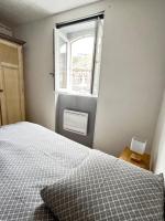 a bedroom with a bed and a window at Appartement calme, plein-centre de Douai in Douai