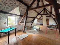 a room with a ping pong table in a attic at L&#39;Echappée d&#39;Aristide - proche Giverny &amp; 50 min Paris in Houlbec-Cocherel