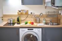 a kitchen counter with a washing machine and a sink at Studio cosy Valmy- Vaise-Lyon centre in Lyon