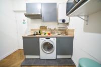 a kitchen with a washing machine and a sink at Studio cosy Valmy- Vaise-Lyon centre in Lyon