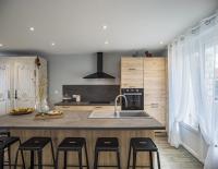 a kitchen with a sink and a counter with stools at Le Flamboyant - Confort &amp; Rareté - Premium in Saint-André-les-Vergers