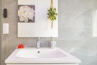 a bathroom with a white sink and a mirror at Le Flamboyant - Confort &amp; Rareté - Premium in Saint-André-les-Vergers