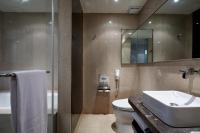 a bathroom with a sink and a toilet and a mirror at The Tango Hotel Taipei Nanshi in Taipei