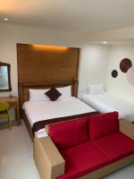 a hotel room with two beds and a couch at 開心居-正市中心電梯民宿-步行東大夜市5分鐘 in Hualien City