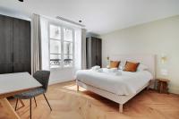 a bedroom with a bed and a table and a desk at Spacious &amp; Modern Home in Central Paris - 3BR8P - A40 in Paris