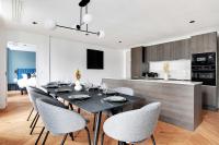 a dining room with a black table and chairs at Spacious &amp; Modern Home in Central Paris - 3BR8P - A40 in Paris