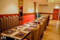 a row of tables in a restaurant with chairs at Hotel A9 Barnala in Barnāla