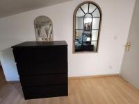 a black dresser in a room with a mirror at Maison Belissima in Marseille