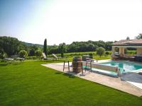 a backyard with a swimming pool and green grass at Villa Maurine - Piscine chauffée - Spa - Clim - Salle de Fitness in Castelnau-de-Montmiral