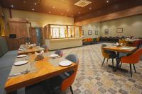 a dining room with long tables and chairs in it at Hotel CP Palace in Patna