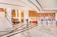 a lobby of a hotel with a staircase at Sheraton Abu Dhabi Hotel & Resort in Abu Dhabi