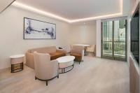 a waiting room with tables and chairs in a building at Sheraton Abu Dhabi Hotel & Resort in Abu Dhabi