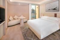 a bedroom with a large white bed and a couch at Sheraton Abu Dhabi Hotel & Resort in Abu Dhabi