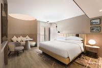 a bedroom with a bed and a table and a chair at Sheraton Abu Dhabi Hotel & Resort in Abu Dhabi