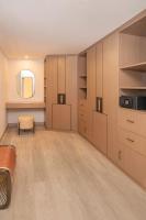 a large room with wooden cabinets and a mirror at Sheraton Abu Dhabi Hotel & Resort in Abu Dhabi